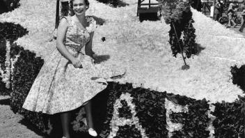 Cynthia Leivers, student hostess for a recent Picnic Day, is shown with one of the fraternity parade floats, 1954.jpg