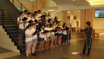 Singers on central staircase in Shields Library.jpg